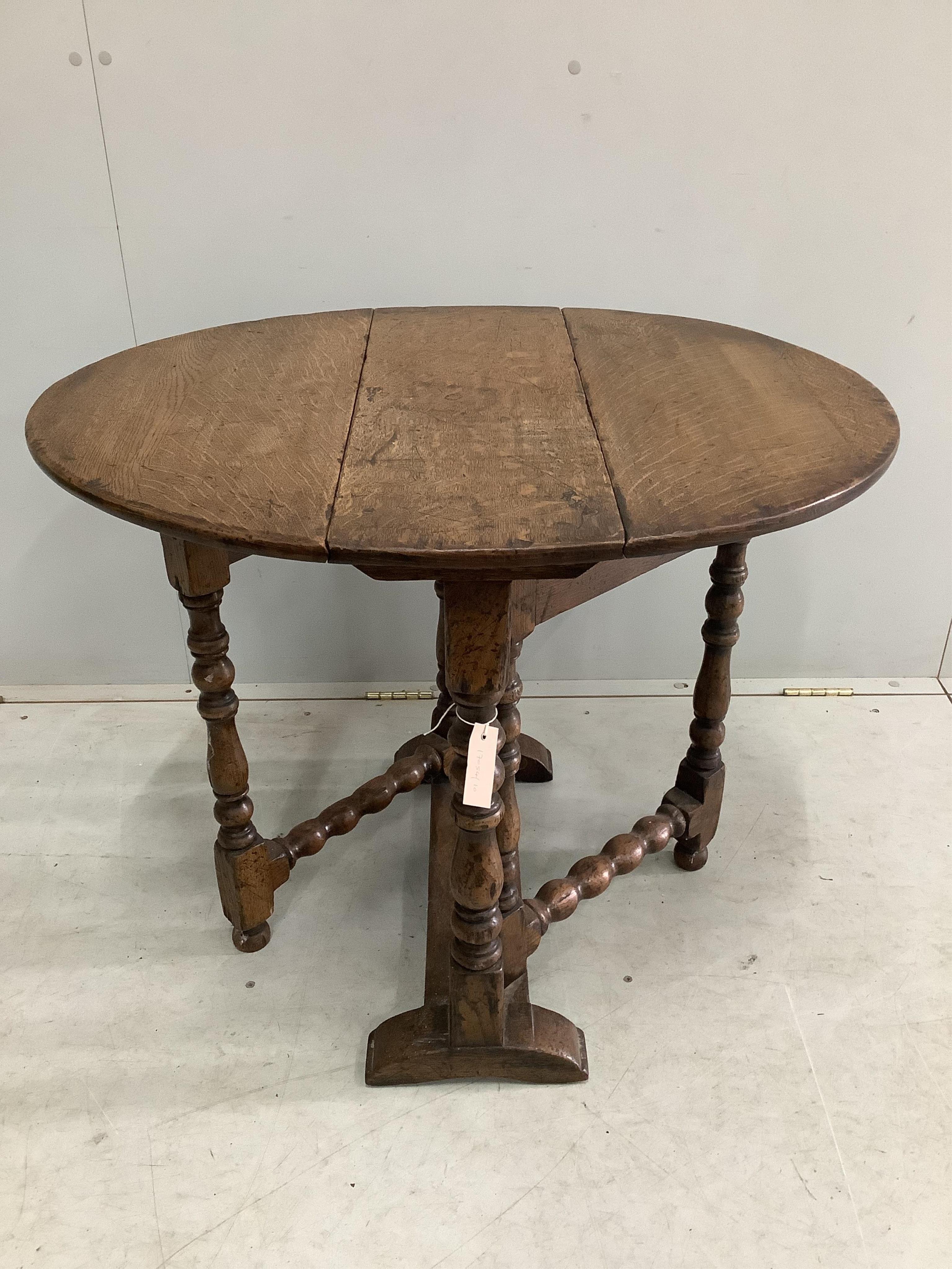 A small 17th century style oak gateleg occasional table, width 65cm, depth 26cm, height 65cm. Condition - fair to good